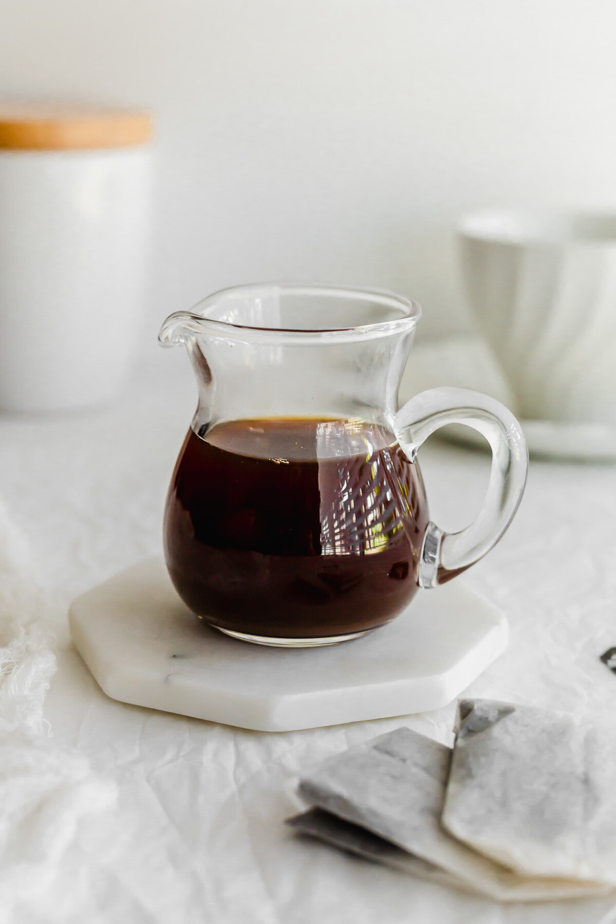Earl grey syrup in a glass pitcher.