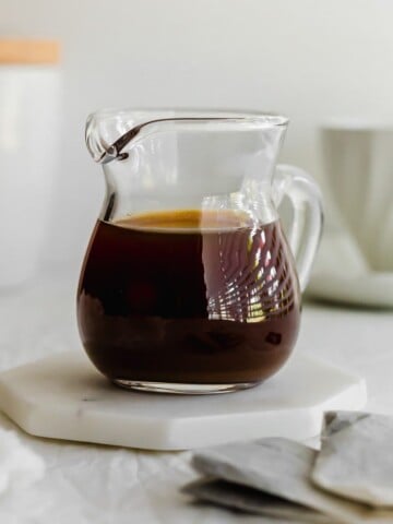 Earl grey syrup in a glass pitcher.