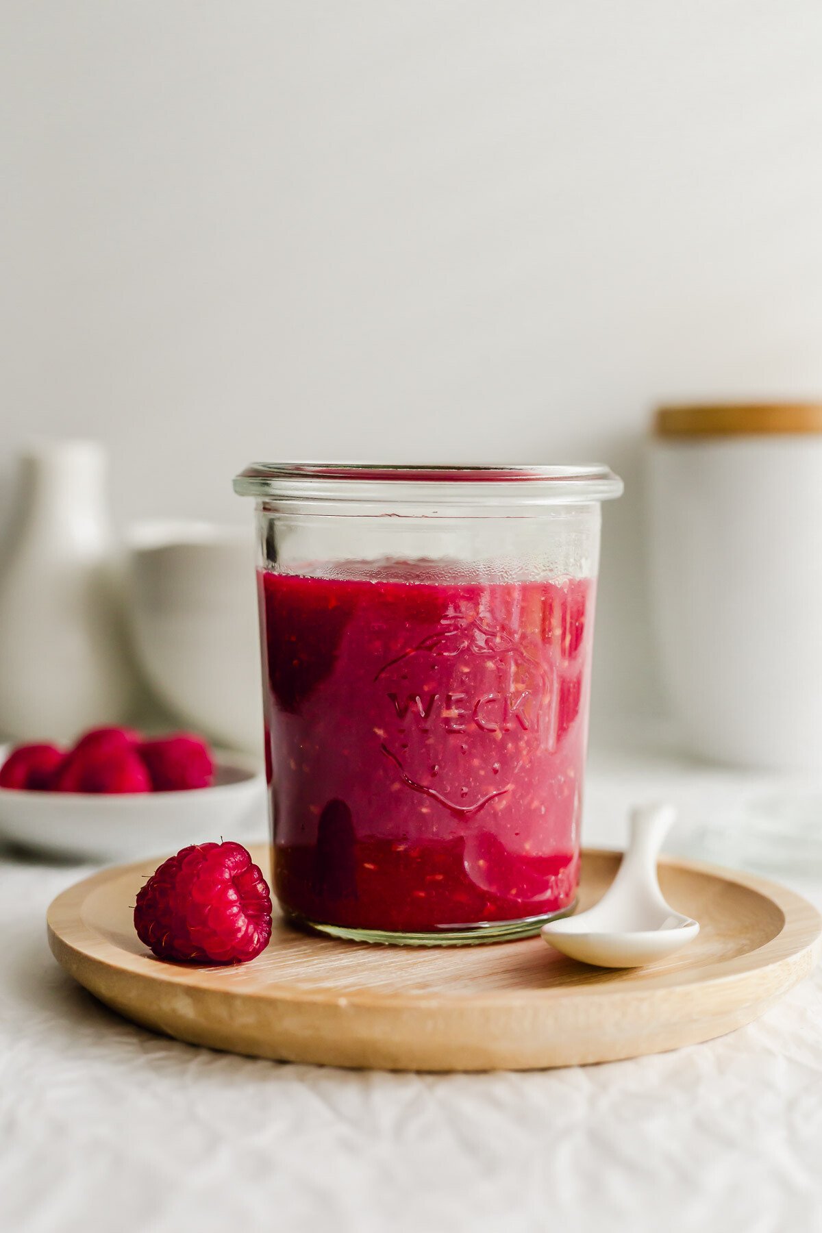 A glass filled with raspberry sauce.