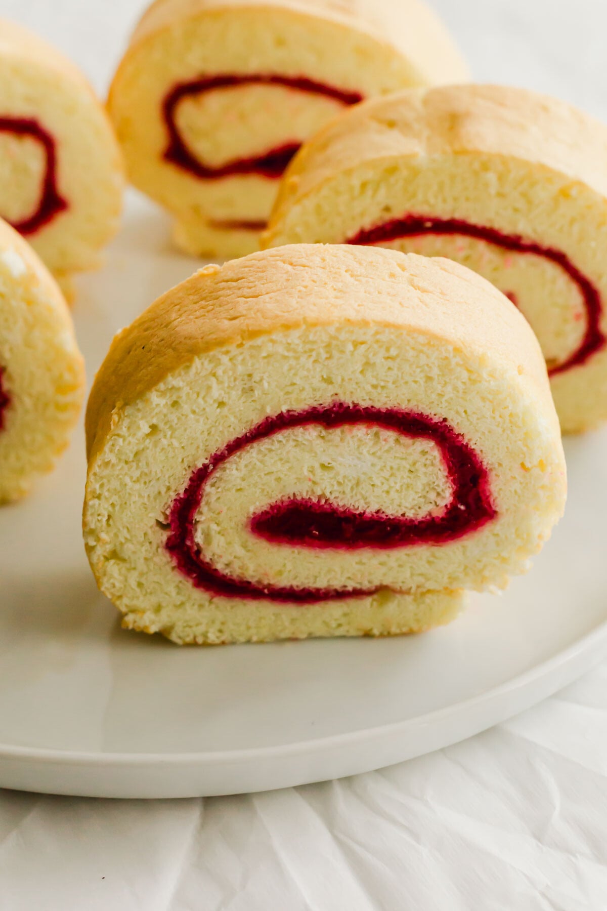 Slices of jelly roll cake on a white plate.