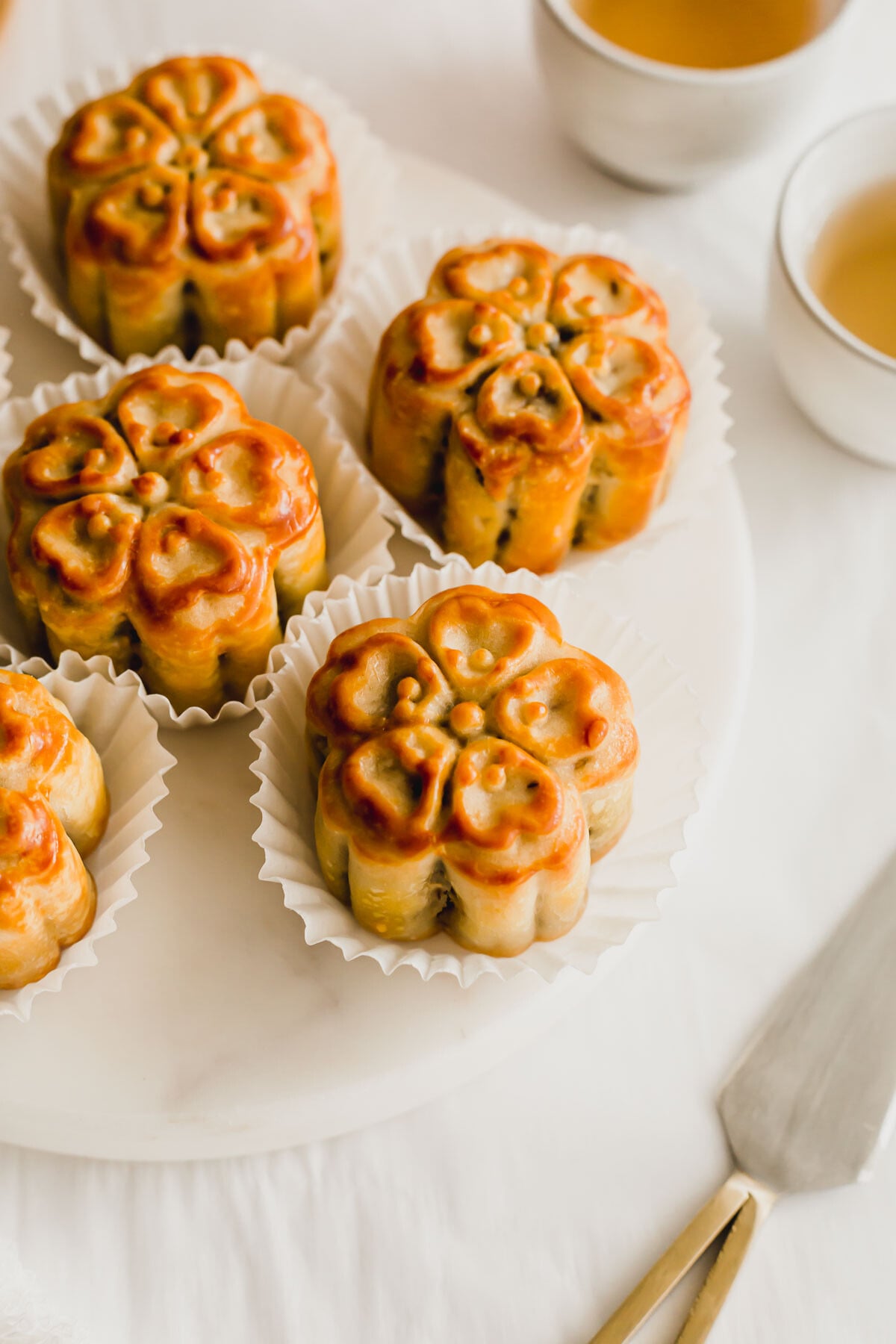 Chinese mixed nuts mooncakes on a white round marble.