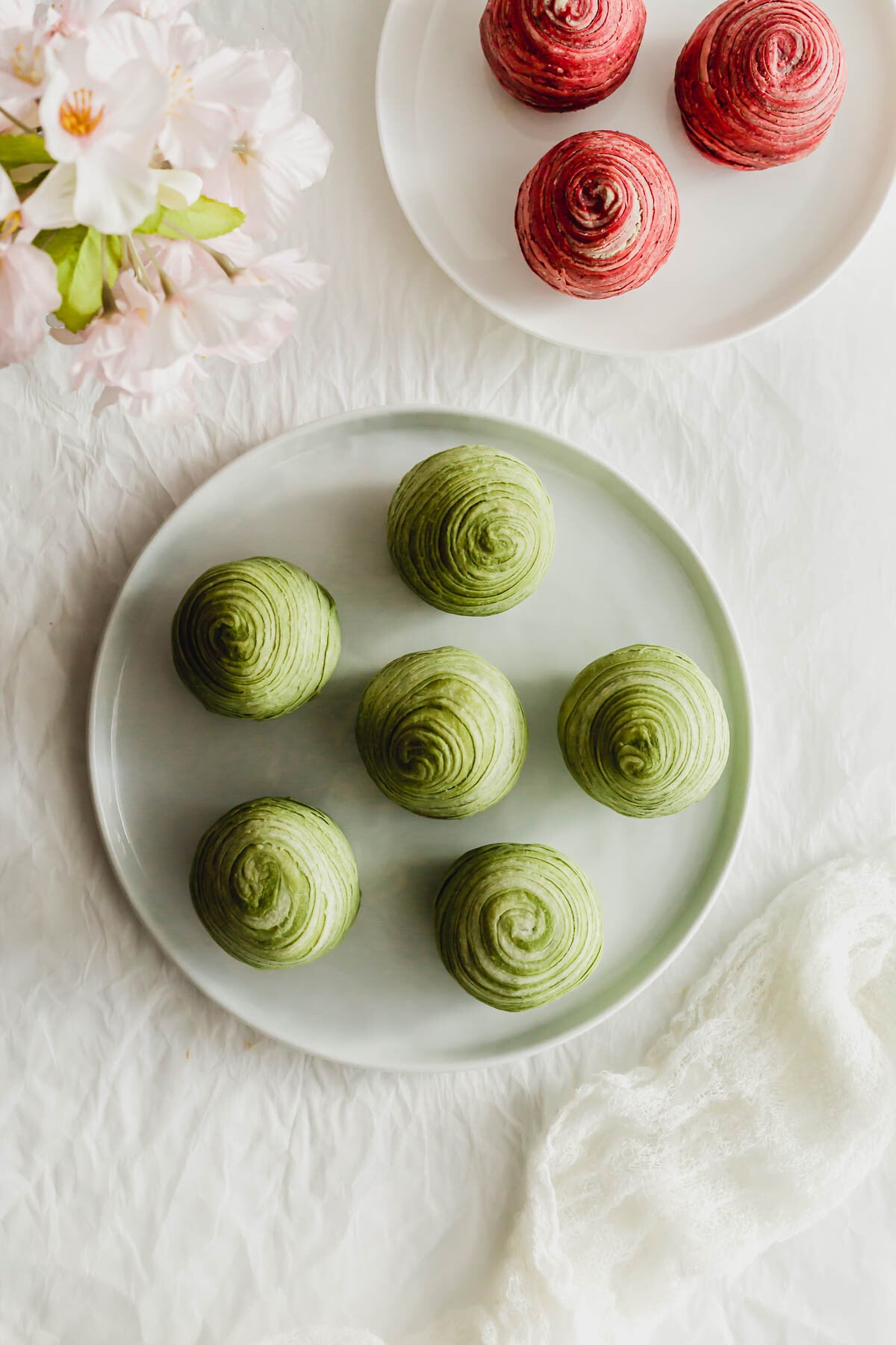Matcha Teochew spiral mooncakes on a white plate.