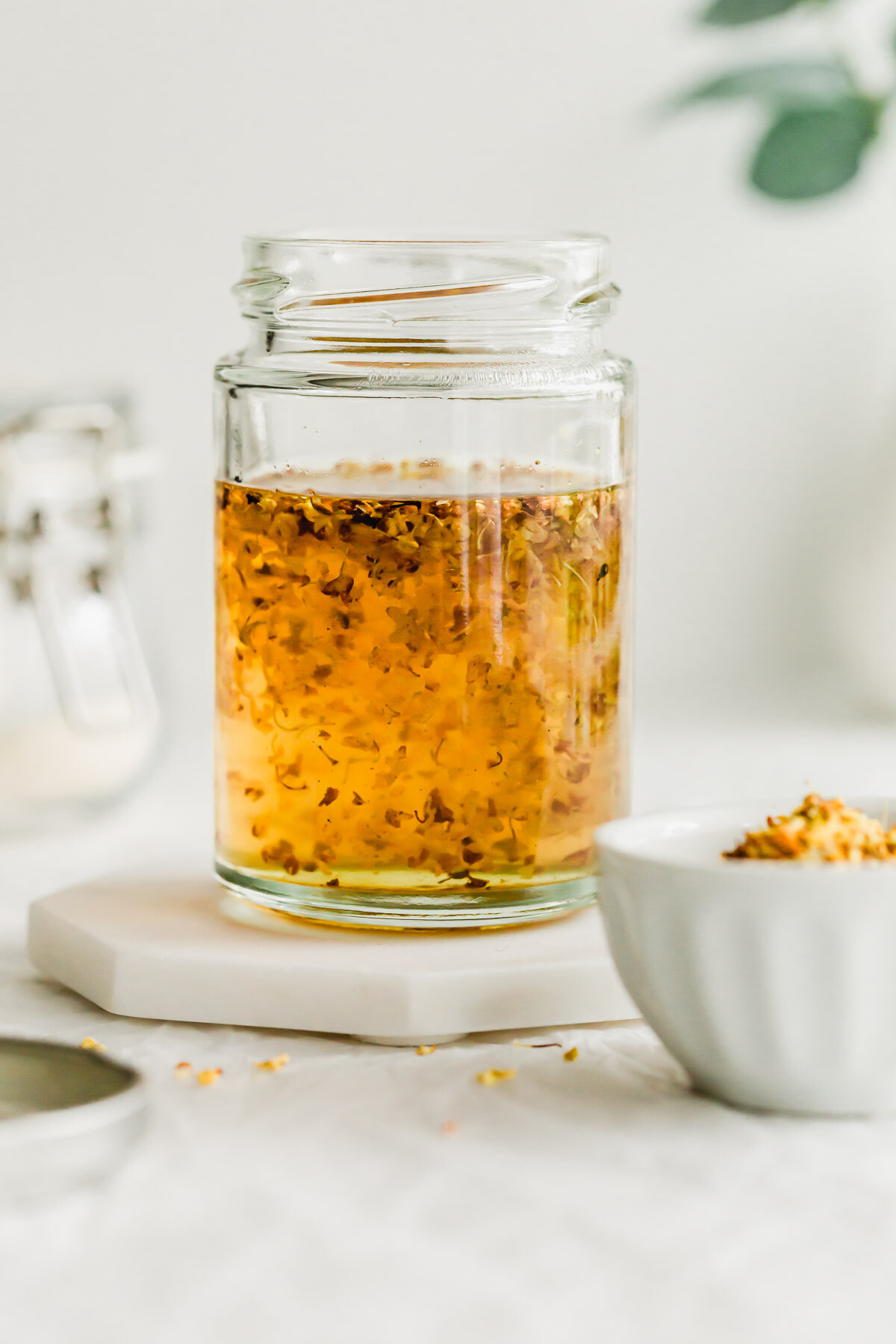 Close up of Osmanthus syrup in a glass jar.