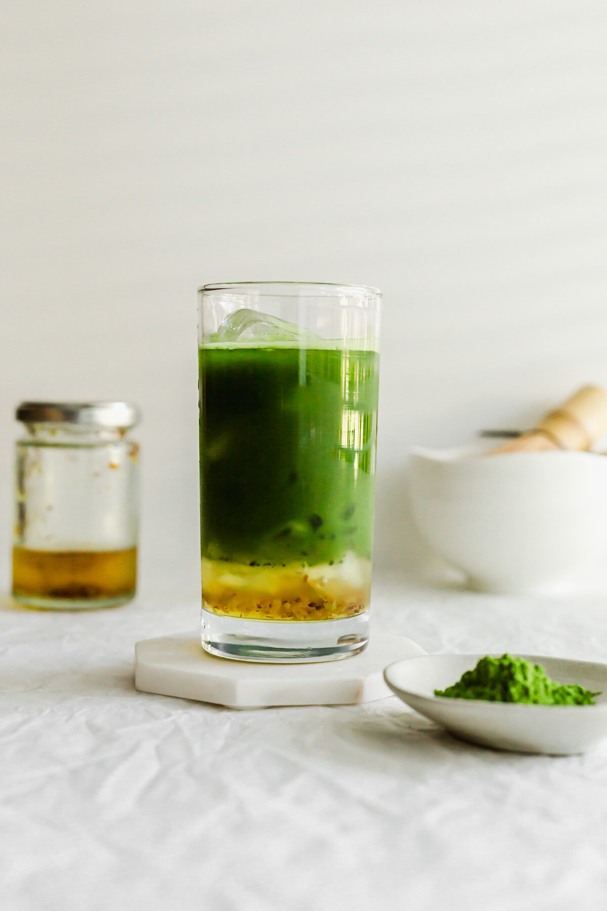 Iced matcha osmanthus tea in a tall glass.