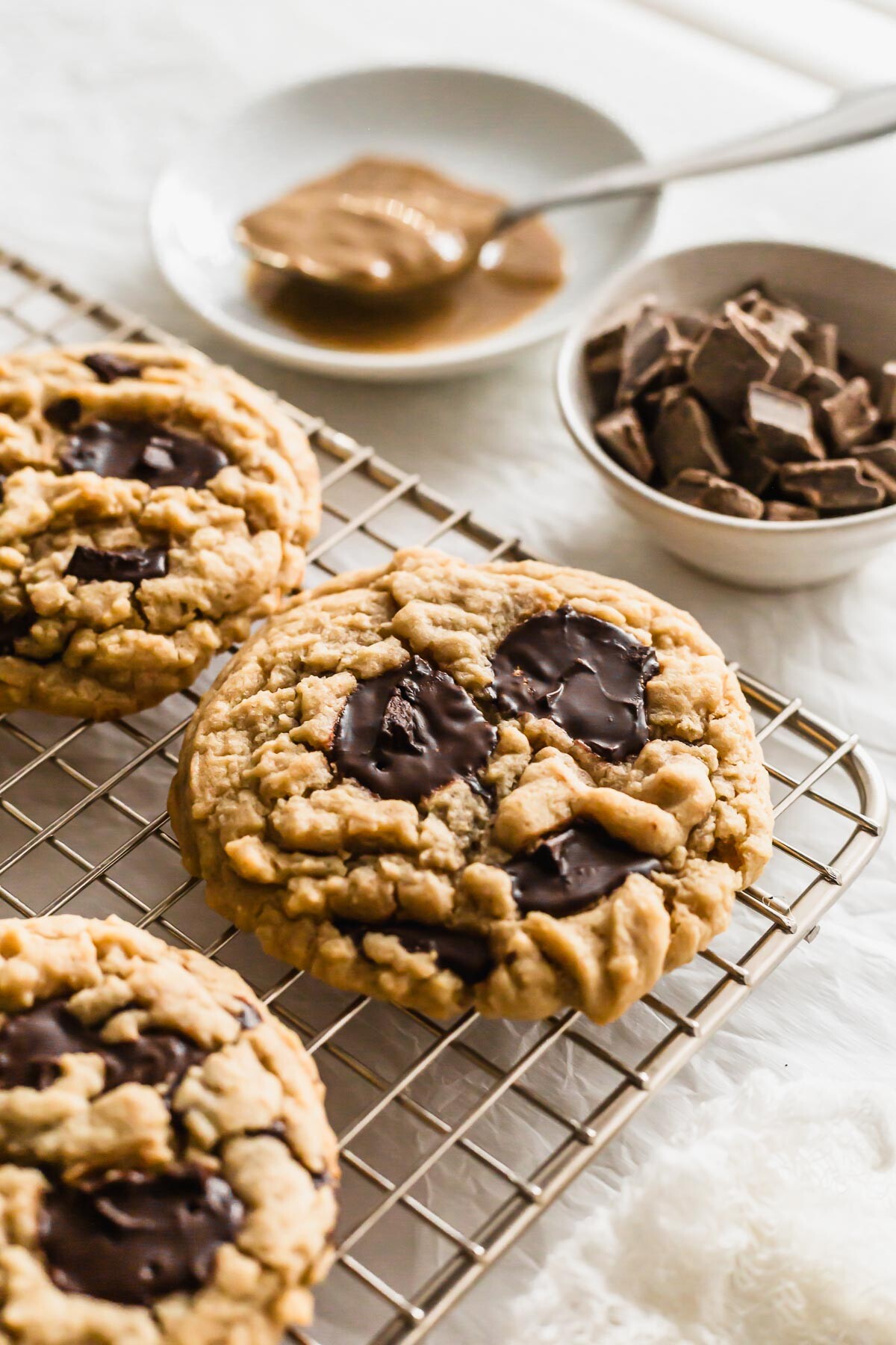 Chocolate tahini cookies on a wire rack.