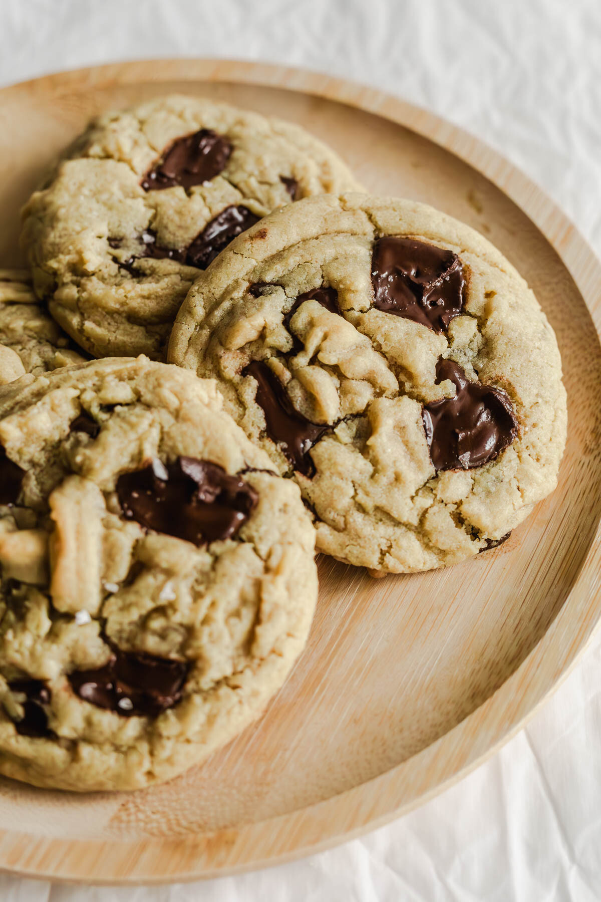Close up of Chocolate chip cookies on a wooden plate.