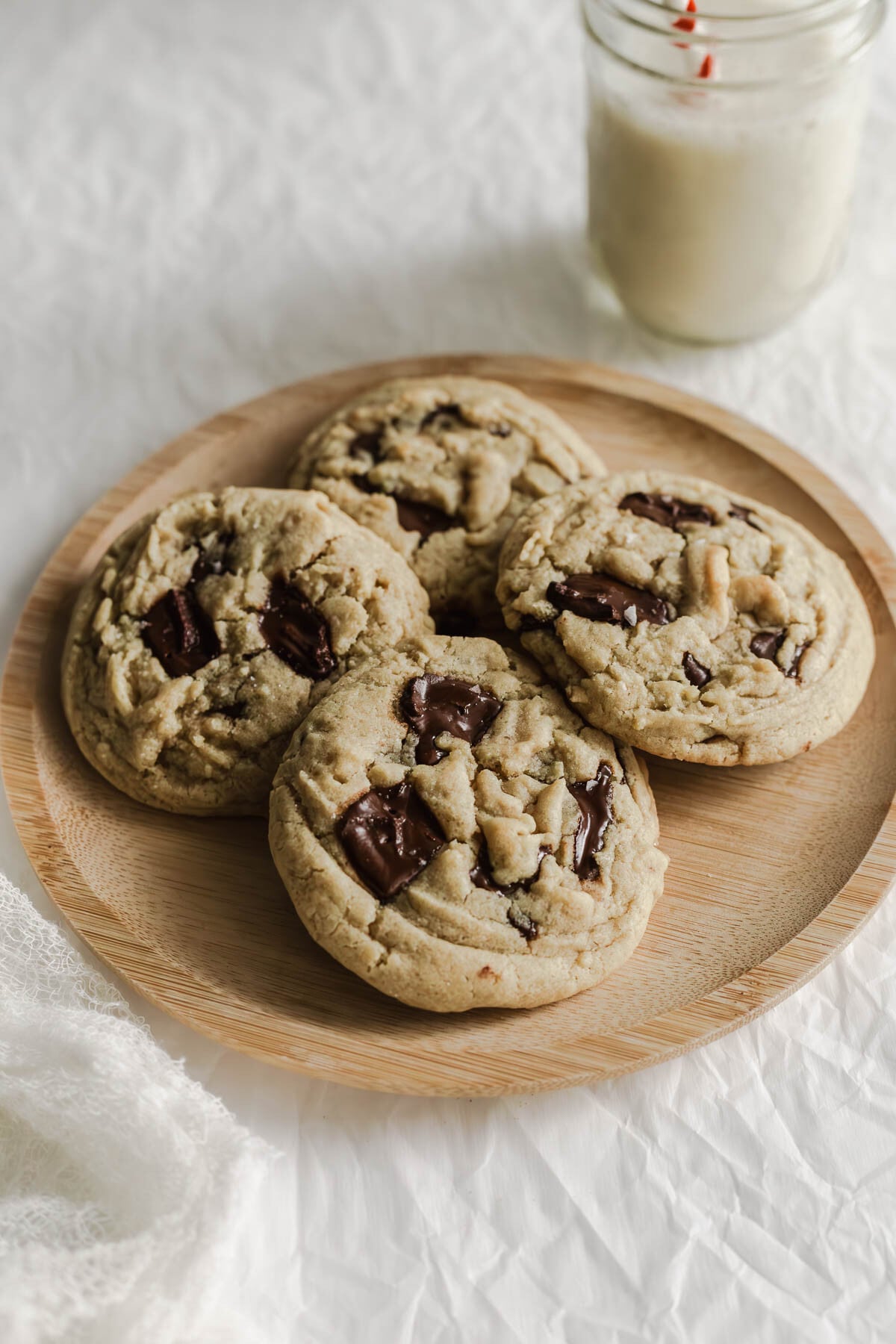 Chocolate chip cookies on a wooden plate.