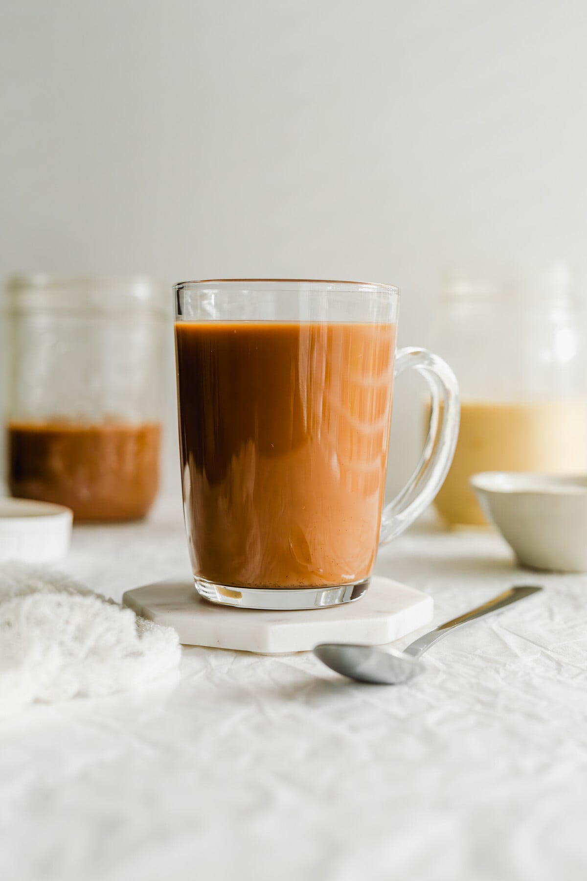 Hong Kong milk tea in a glass tea cup.