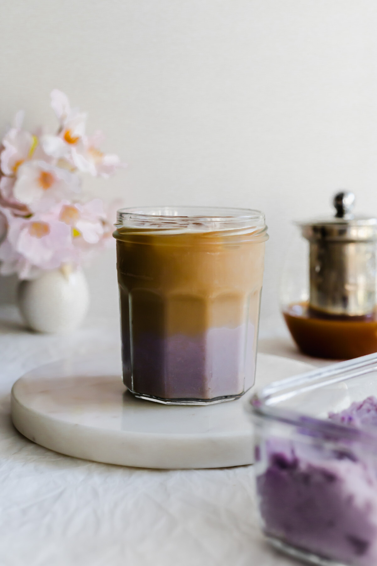 Taro milk tea in a glass jar.