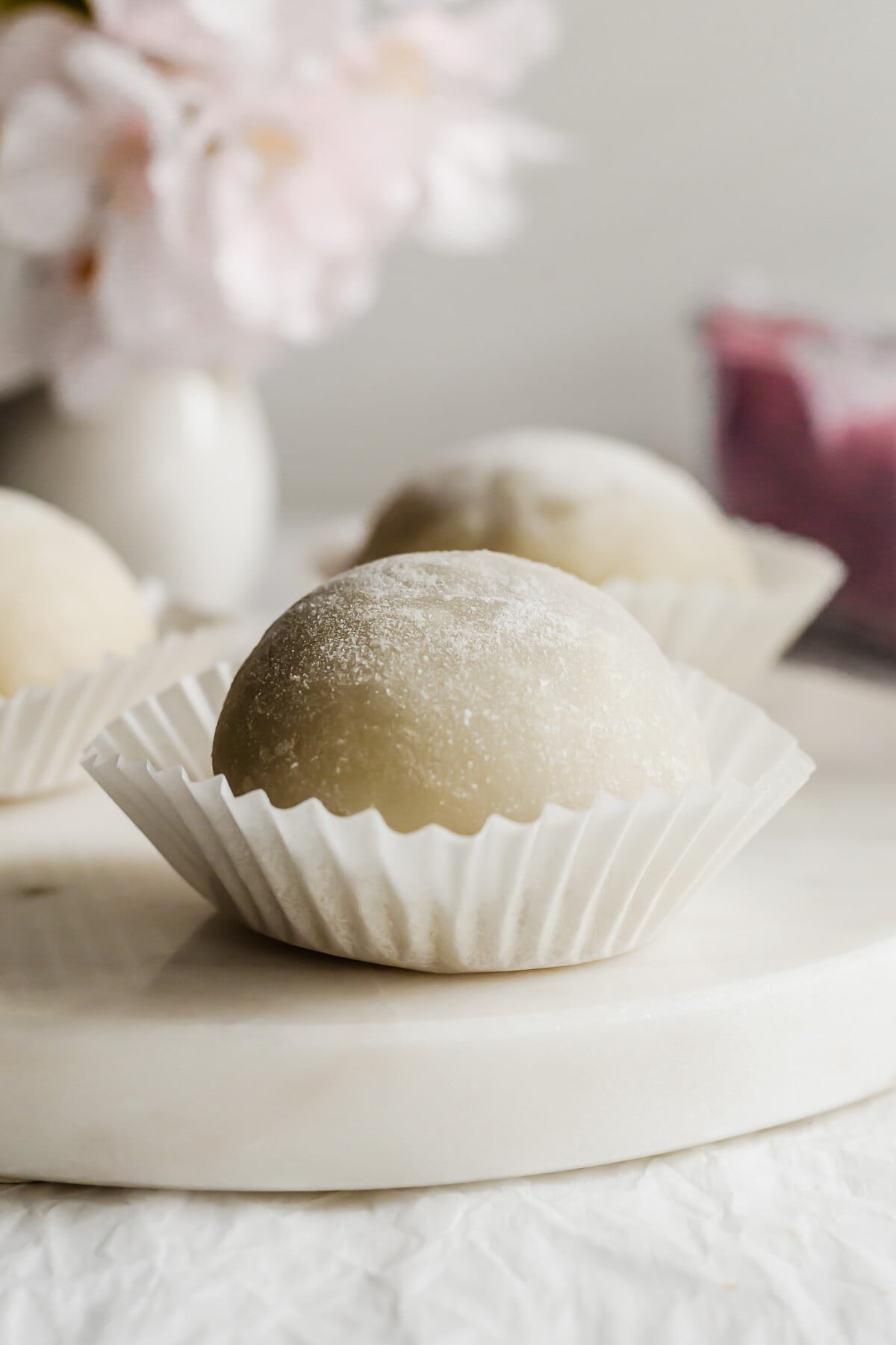 Whole taro mochi on a white round marble.