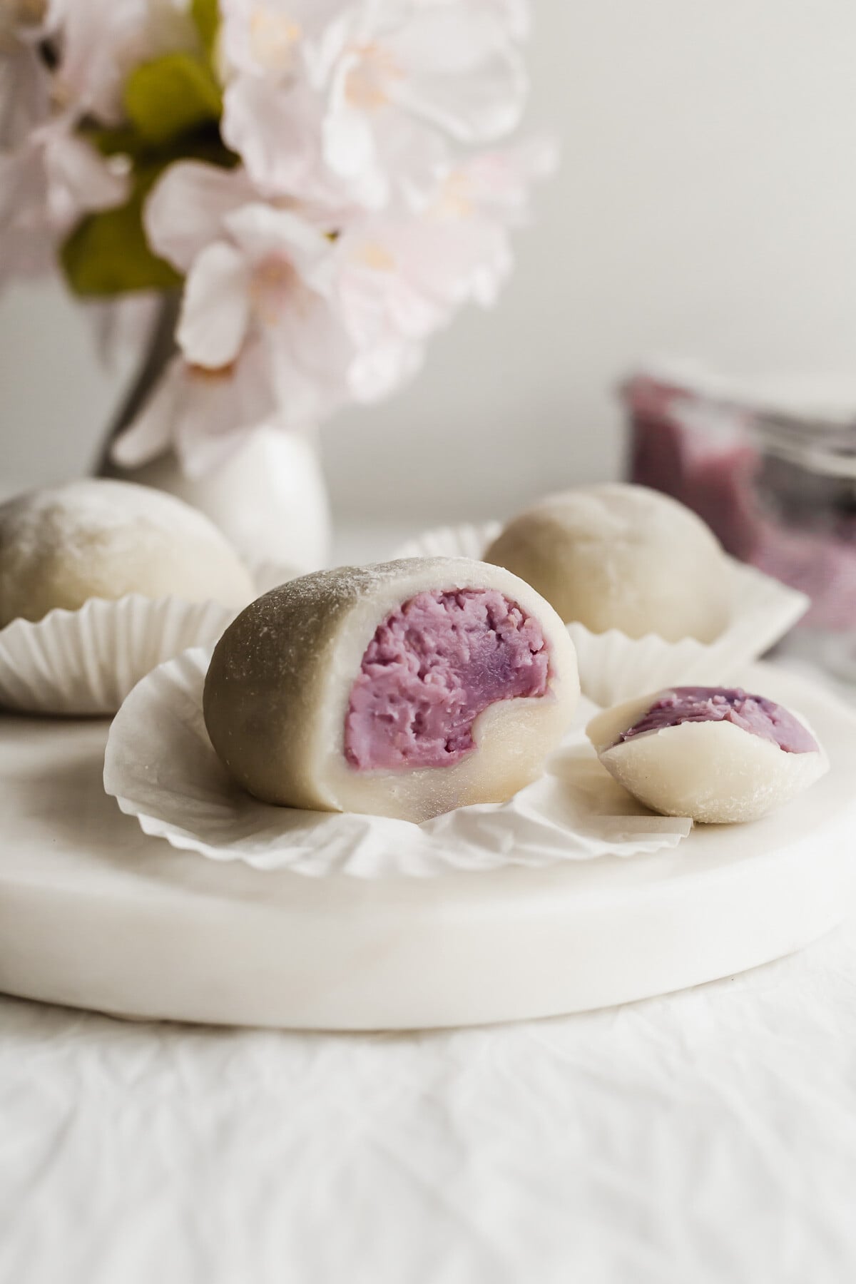 Cut open taro mochi on a white round marble.