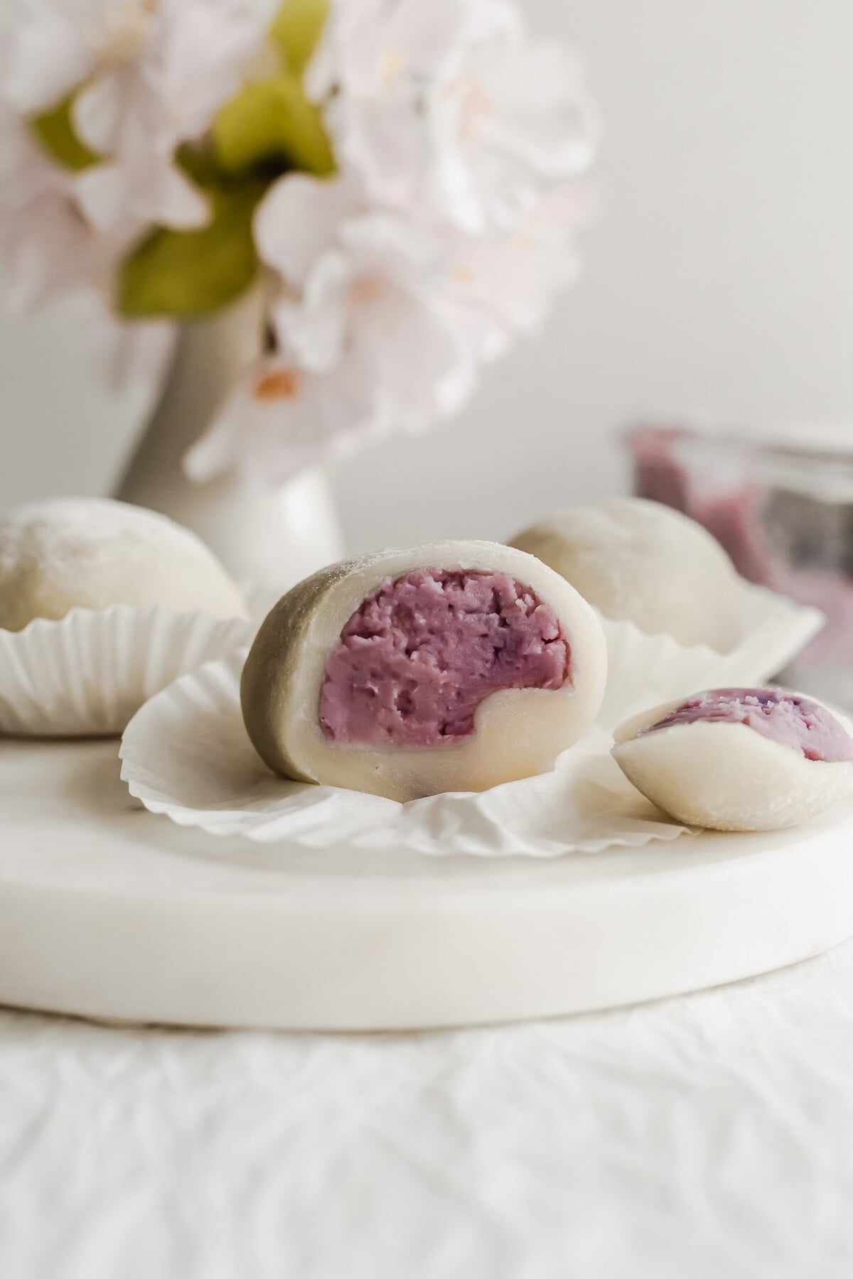 Cut open taro mochi on a white round marble.